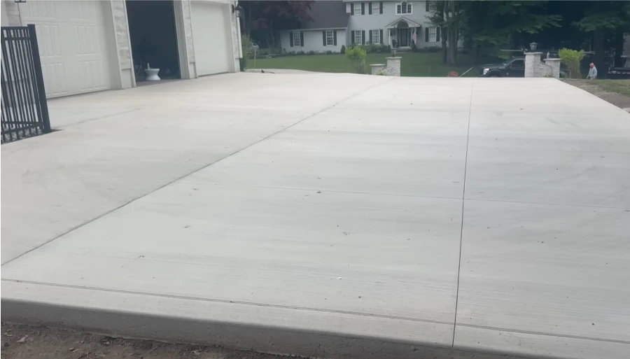 Best concrete driveway contractor Kansas City — freshly poured smooth slab with expansion joints