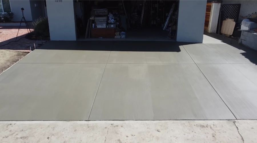 Completed concrete driveway Kansas City — smooth brushed finish with clean expansion joints