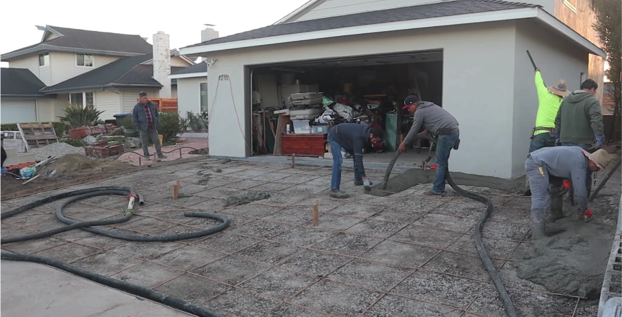 Driveway installation in progress — Kansas City crew pouring concrete over rebar grid