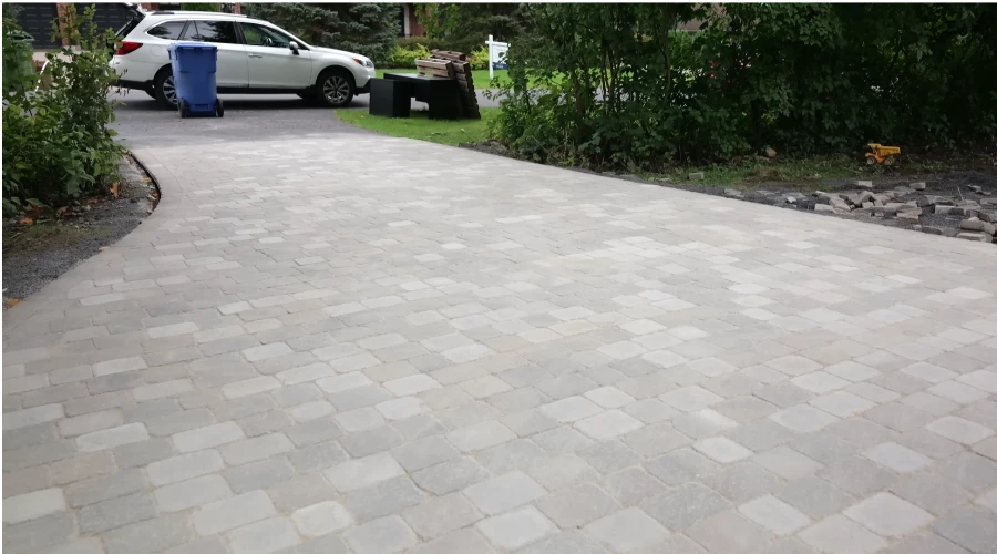 Decorative concrete paver driveway Kansas City — curved design with natural stone look